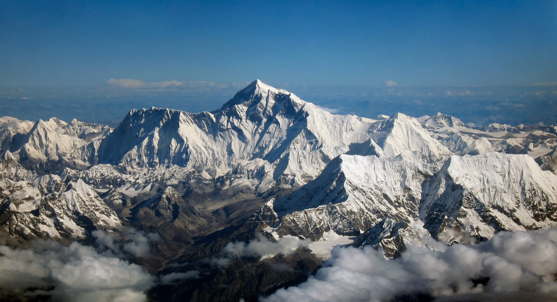 Everest, Lhotse and surrounding peaks seen from an aircraft. Original photograph from 2006, edited in 2012. A regional panorama, not a photograph of the 2025 expedition.